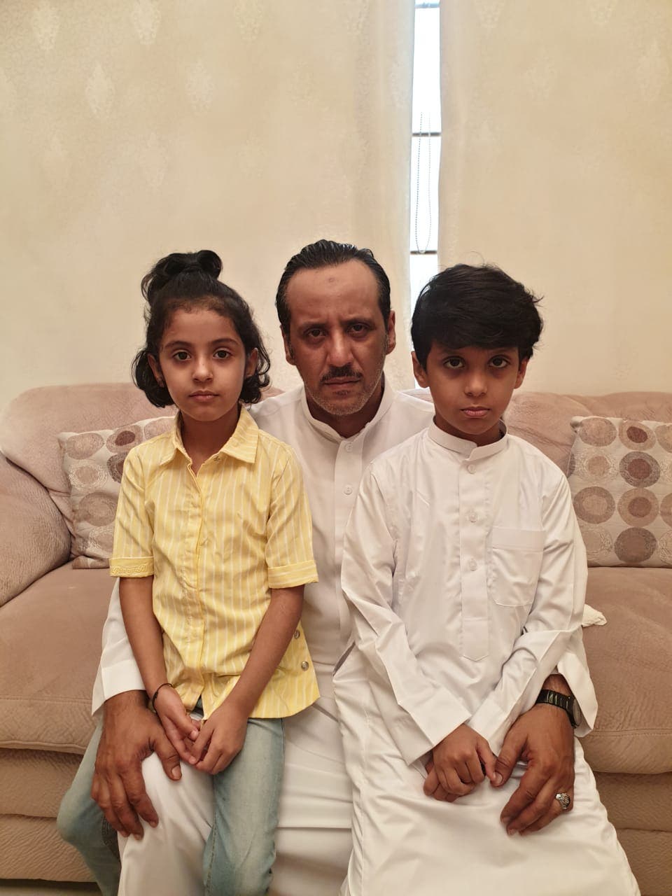 الأب مع أطفاله الصغار بعد أن فقدوا أمهم