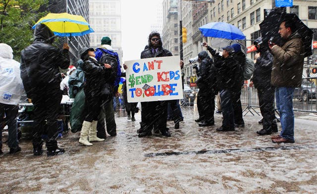 A member of the Occupy Wall Street movement demonstrates in Zuccotti Park during the first snow fall of winter in New York. (Reuters)