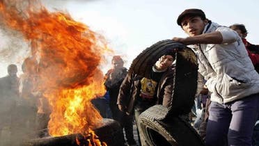 Egyptian al-Ahly football club supporters (Ultras) set fire on tires in Cairo’s downtown six October bridge on Jan. 23, 2013 demanding justice for the victims of the 2012 Port Said football match killings, a few days ahead of a court ruling on the matter. (AFP)