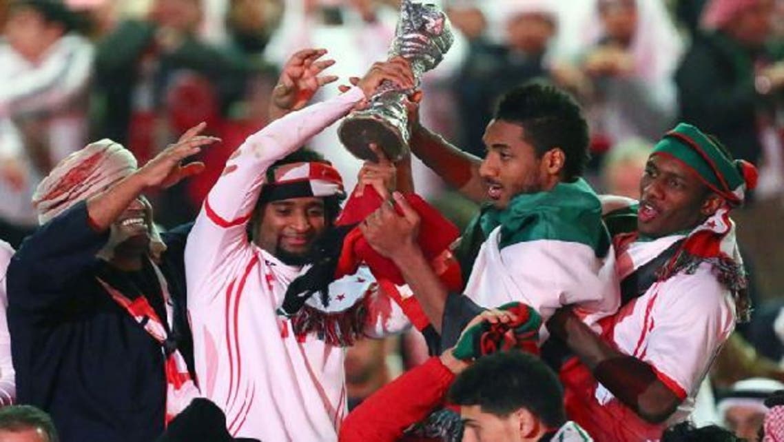 Emirati players celebrate with their trophy after winning the final of the 21st Gulf Cup on Jan. 18, 2013 in Manama. (AFP)