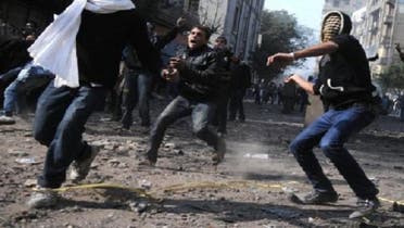 Egyptian protesters throw stones during clashes with riot police near Tahrir Square in Cairo on Nov. 23, 2011. An Egyptian court on Saturday dropped charges against 379 people involved in clashes against the police in 2011, following a decree by President Mohamed Mursi granting them amnesty, the official MENA news agency said. (AFP)