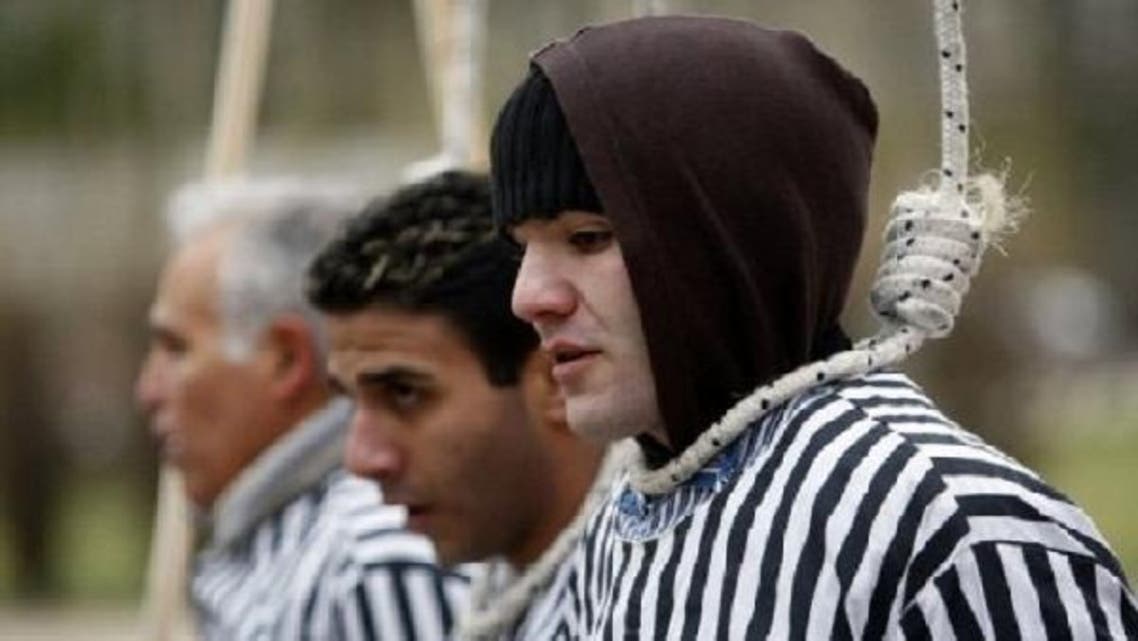 Activists of the Iranian Resistance simulate death by hanging as they demonstrate in 2008 in front of the foreign ministry in Berlin. Iran hanged two men in public on Sunday, after a video posted on YouTube last month showed them assaulting a man in a Tehran street with a machete, the ISNA news agency reported. (AFP)