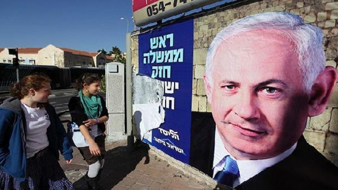 Youths look at a Likud-Yisrael Beitenu campaign poster depicting Israel’s Prime Minister Benjamin Netanyahu in Jerusalem January 17, 2013. Netanyahu looks set to form a new governing coalition after next week\'s election, polls show, with the only question being whether he wants to soften its hardline contours. (Reuters)