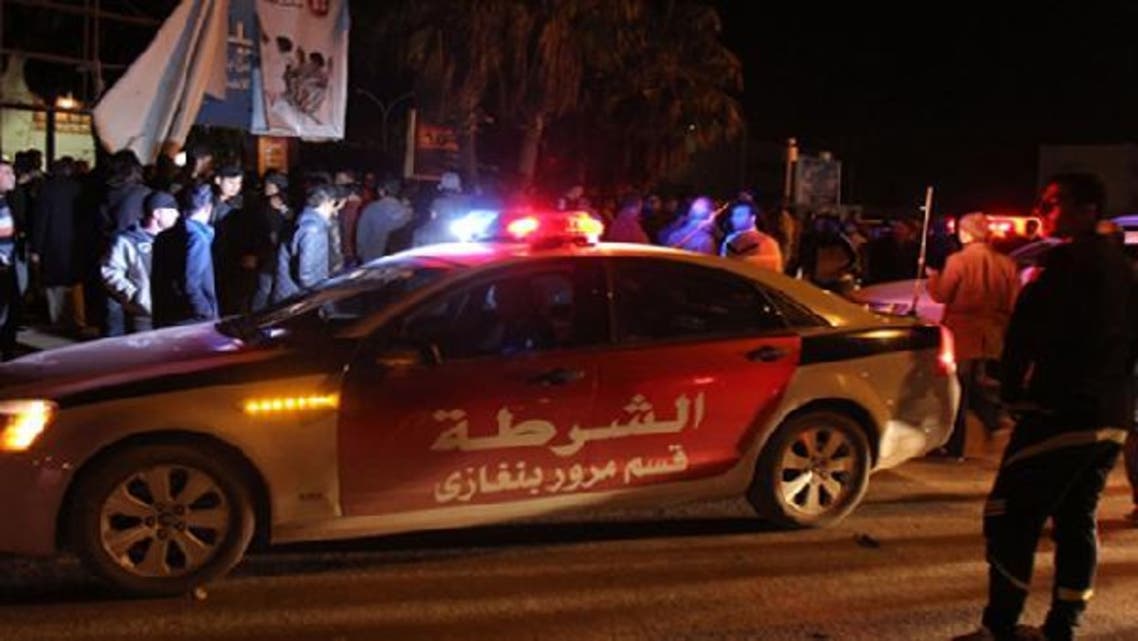 Libyans and police gather at the scene where an improvised bomb hit a police patrol car late on January 14, 2013 in a central neighborhood of the eastern city of Benghazi. (AFP)