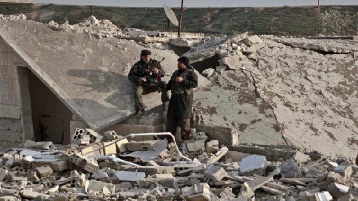 Members of Free Syrian Army take a rest near a damaged house at the front line in Hich village in Idlib January 22, 2013. (Reuters)