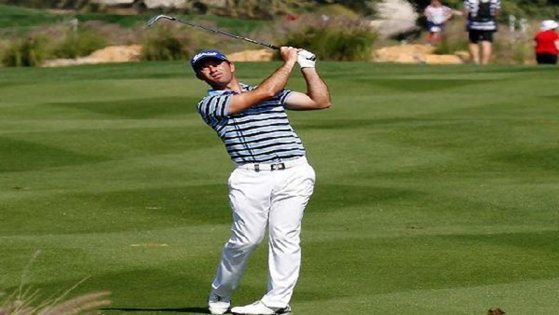 Ricardo Santos of Portugal plays a shot at the 17th during the first round of the Commercial Bank Qatar Masters at the Doha Golf Club Jan. 23, 2013. (Reuters)