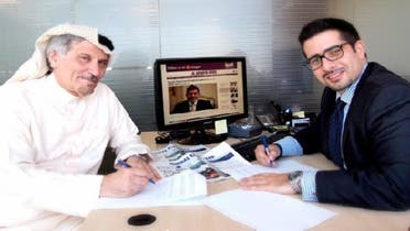 Khaled Al-Maeena, Editor-in-Chief of The Saudi Gazette  (left) and Faisal J. Abbas, Editor-in-Chief of Al Arabiya News Channel’s English language portal (right) sign a content-sharing agreement. (Katherine Jane O\'Neill, Al Arabiya)