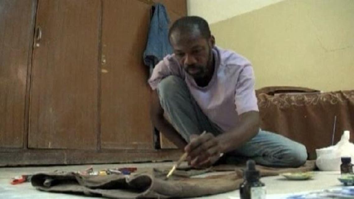 Sudanese poet and artist, Asim Ali uses his old trousers as a canvas to share memorable moments of his life. (Reuters)