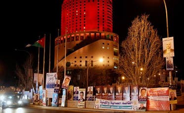 Cars drive past parliamentary election campaign posters in central Amman January 22, 2013. (Reuters)