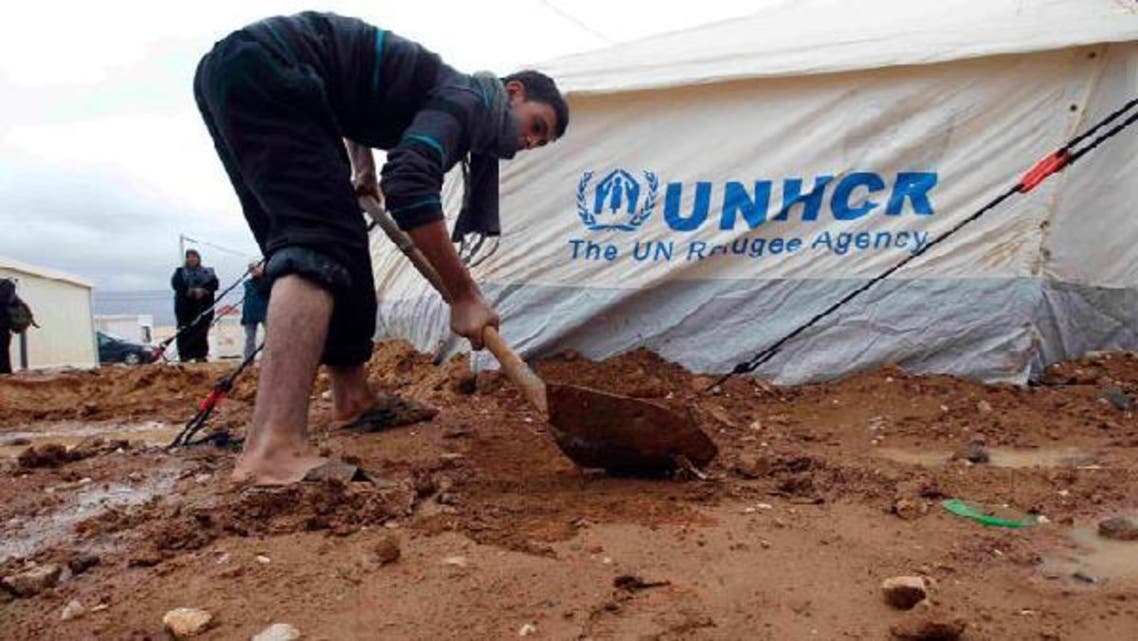 A Syrian refugee fixes his tent after heavy rain at the Al-Zaatari refugee camp in the Jordanian city of Mafraq, near the border with Syria, January 8, 2013. (Reuters)