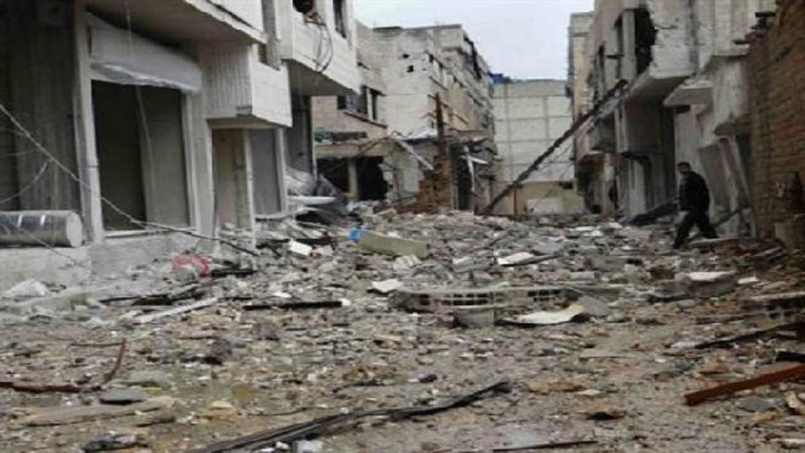 A man walks near buildings damaged by what activists said were missiles fired by a Syrian Air Force fighter jet loyal to President Bashar al-Assad in Erbeen, near Damascus, in a picture provided by Shaam News Network Jan. 6, 2013. (Reuters)