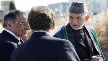 President of Afghanistan Hamid Karzai (R) walks alongside U.S. Defense Secretary Leon Panetta (L) on a guided tour of the Pentagon Memorial, in memory of the victims of the September 11 attack, at the Pentagon in Arlington, Virginia, Jan. 10, 2013. (Reuters)