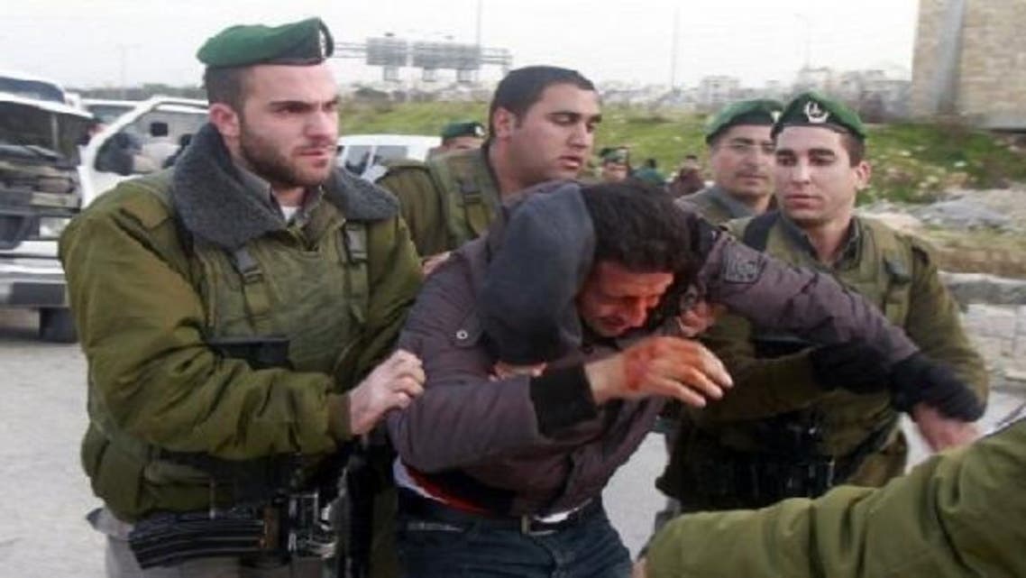 Israeli border police are seen as they remove Palestinians from an outpost of tents in an area known as E1, near Jerusalem Jan. 13, 2013. (Reuters)