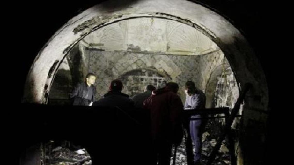 Forensic police inspect the damage at a burned mausoleum of Sidi Bou Said in the northern suburbs of Tunis on Sunday. The cause of the fire remains unknown, according to local media. (Reuters)