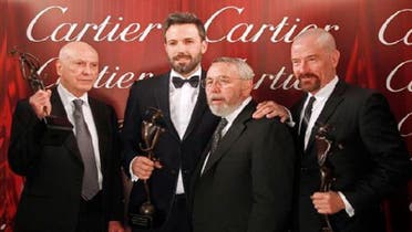 Cast members of “Argo”, Alan Arkin, Ben Affleck and Bryan Cranston pose with the presenter of the award, former CIA agent Tony Mendez at the 24th Annual Palm Springs International Film Festival Gala on January 5, 2013. (Reuters)