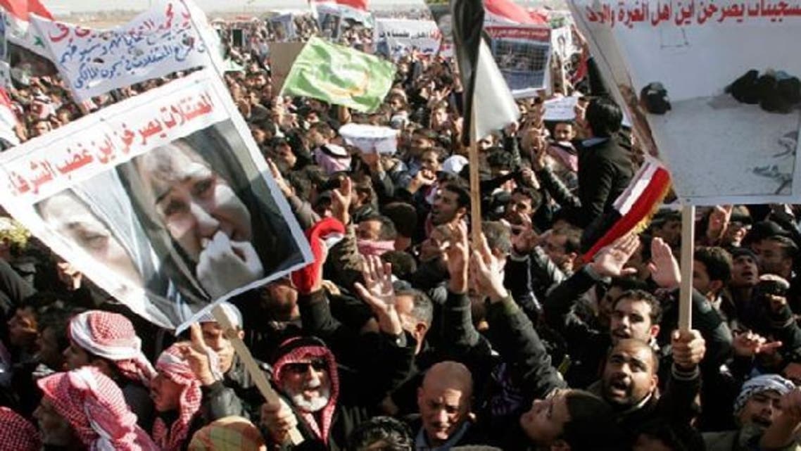 Protesters take part in a demonstration in Ramadi, 100 km (62 miles) west of Baghdad, December 26, 2012. Tens of thousands of Sunni Muslims blocked Iraq’s main trade route to neighboring Syria and Jordan in a fourth day of demonstrations on Wednesday against Shiite Prime Minister Nuri al-Maliki. The banner (bottom left) reads, “Female prisoners ask loudly, ‘Where is the anger of honorable people?’ (Reuters)