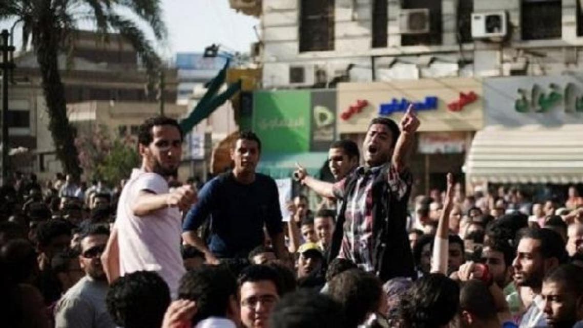 Egyptians protest against a controversial new law that allows the army to court-martial civilians. Mohamed Sabry, a freelance video journalist and activist, was recently arrested under the law. (AFP)