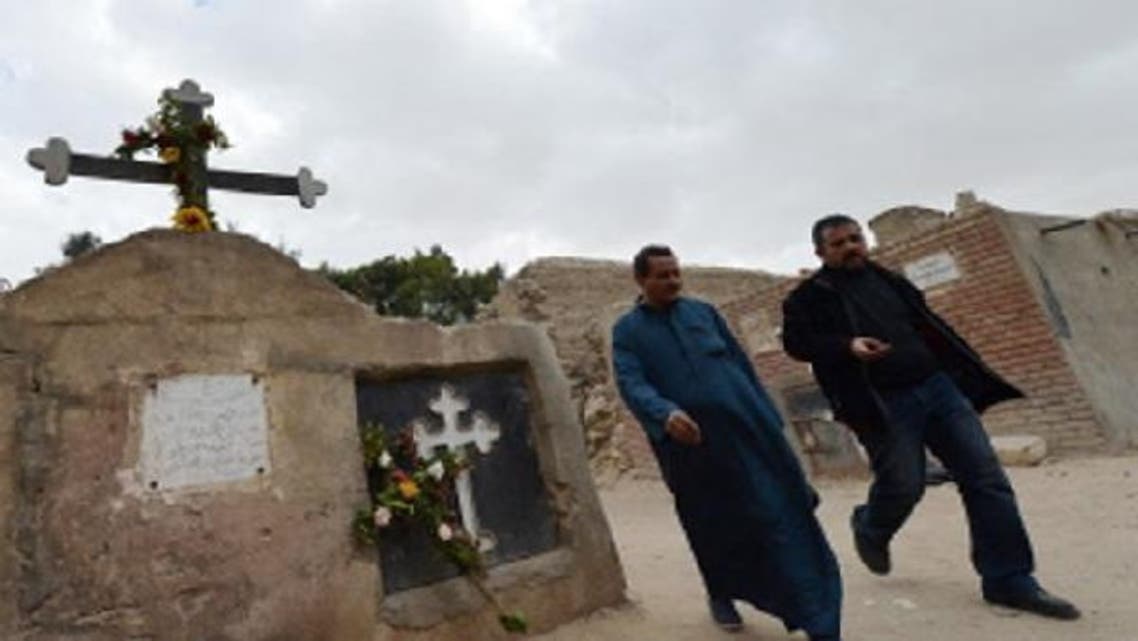 Egyptian Coptic Christian men walk at a cemetery on January 6, 2013 in the historical part of Cairo. The Copts of Egypt will celebrate on Jan. 7, 2013 their first Christmas since the country has been ruled by Islamists in a climate of concern despite assurances from the authorities. (AFP)