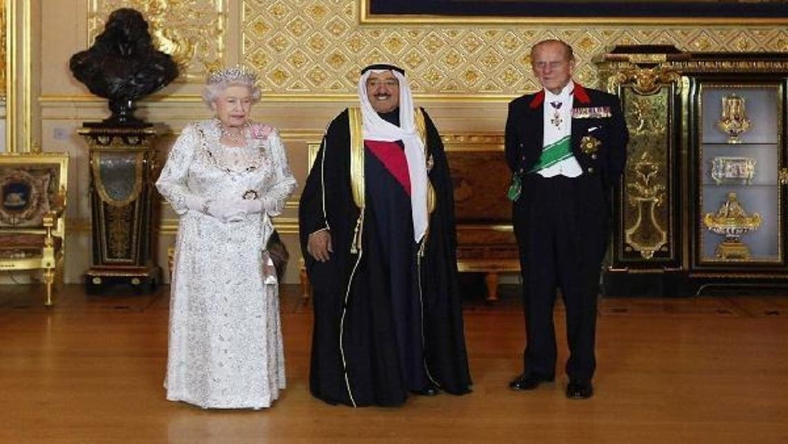 Britain’s Queen Elizabeth (L) poses for a photograph with the Emir of Kuwait, Sheikh Sabah al-Ahmad al-Sabah (C) and her husband Prince Philip before a State Banquet at Windsor Castle, in Windsor, southern England. (Reuters)