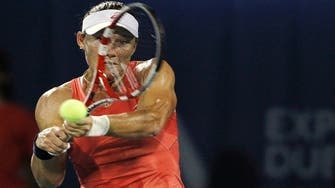 Tennis-Stosur eases through in Dubai, Azarenka pulls out