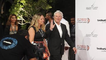 U.S. actor Richard Gere arrives on the red carpet with a festival organizer during the opening of the 6th Abu Dhabi Film Festival. (Reuters)