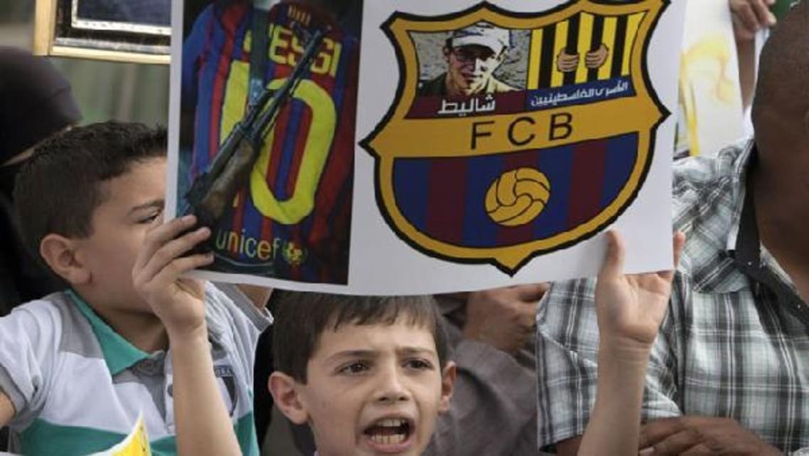 Palestinians protest against the presence of former Israeli captive soldier Gilad Shalit at the upcoming Spanish first division soccer match between Barcelona and Real Madrid, during a demonstration in Jerusalem Oct. 7. (Reuters)