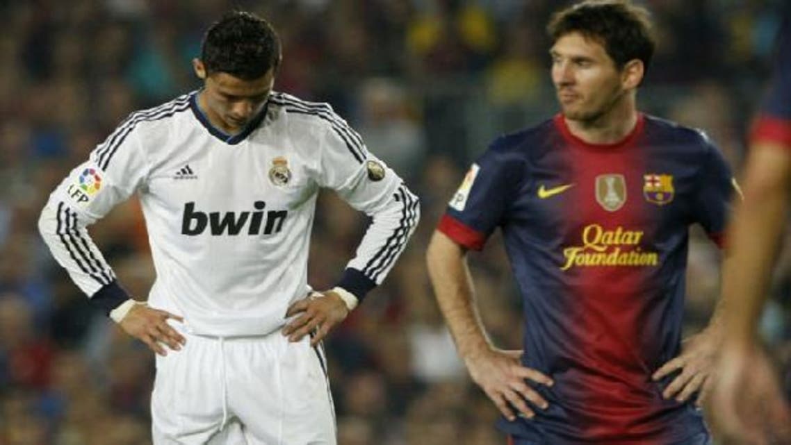 Barcelona\'s Lionel Messi (R) walks past Real Madrid\'s Cristiano Ronaldo during their Spanish first division soccer match at Nou Camp stadium in Barcelona. (Reuters)
