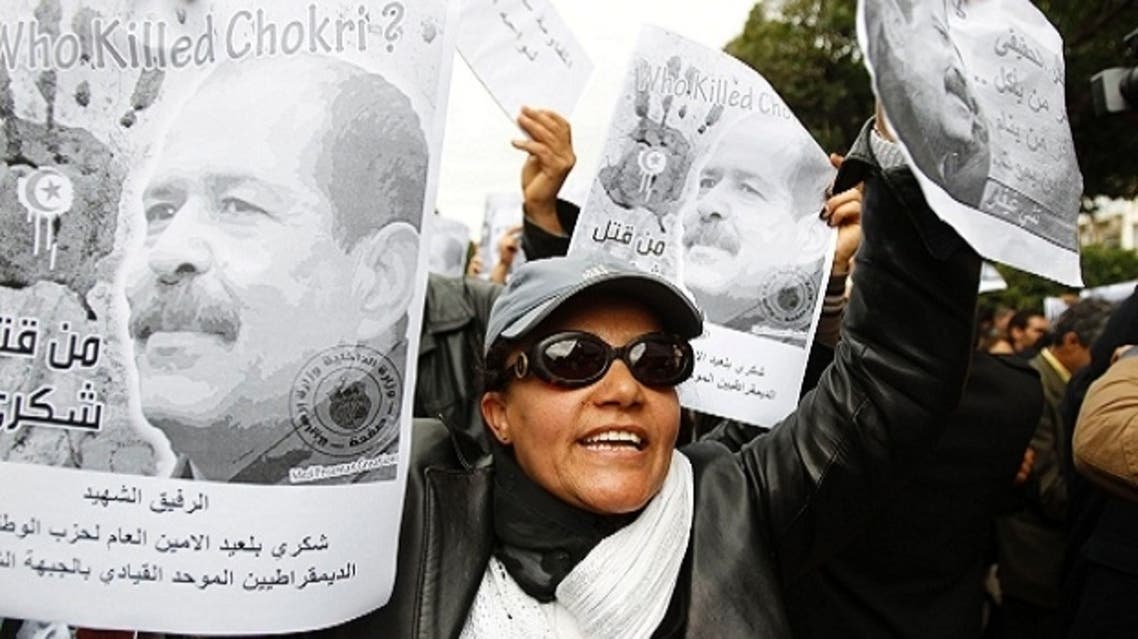 A woman chants slogans and holds pictures of assassinated leftist politician Chokri Belaid during a demonstration against the Islamist Ennahda movement in Tunis February 23, 2013. (Reuters)