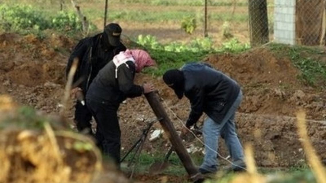 Palestinian fighters prepare to launch a mortar round in Gaza City (File)