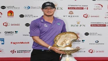 Chris Wood of England celebrates with the winner’s trophy after the final round of the Commercial Bank Qatar Masters at the Doha Golf Club Jan. 26, 2013. (Reuters)