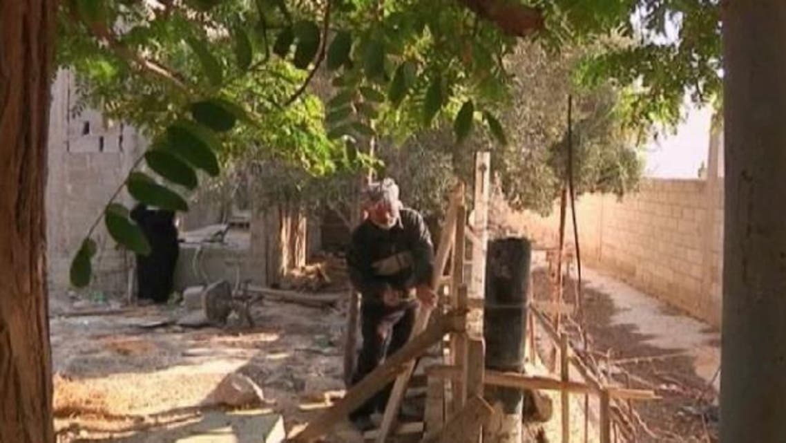 A man from Jericho doesn\'t let his blindness deter him from doing construction work on his own home and that of his neighbors. (Reuters)