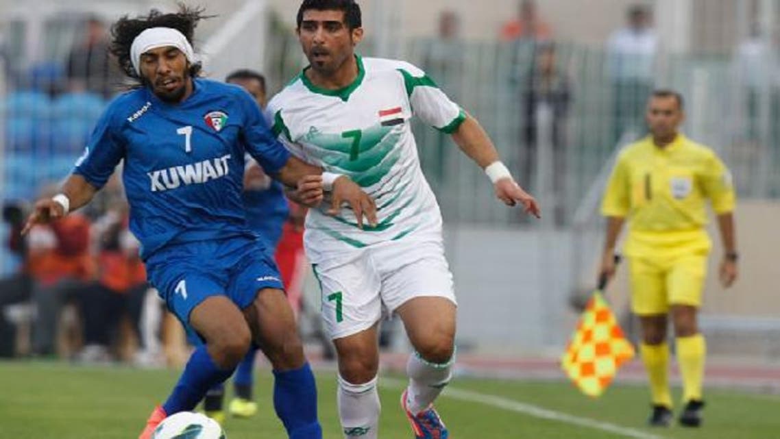Iraq’s Hammadi Ahmed Abdullah (R) and Kuwait’s Fahad Al Enezi fight for the ball during their Gulf Cup tournament soccer match at Khalifa Sports City in Isa Town January 9, 2013. (Reuters)