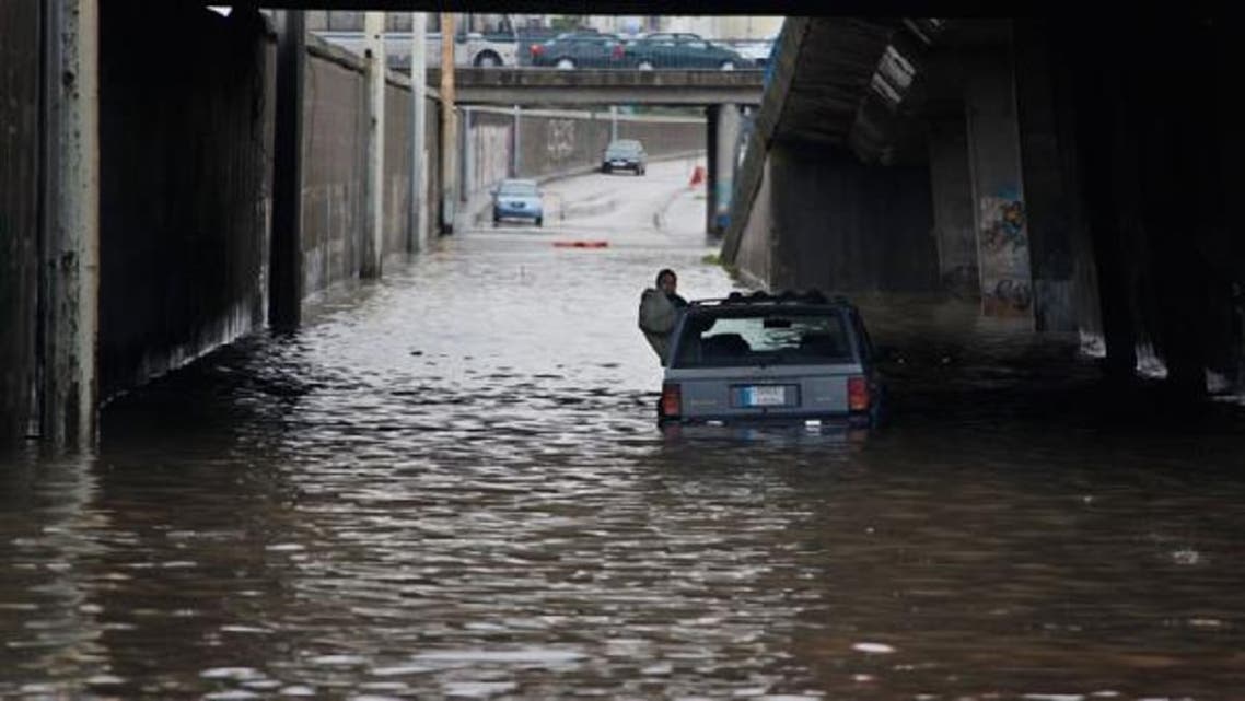 A driver sits in his stranded car on a flooded highway, waiting for help, during a winter storm in Beirut January 7, 2013. (Reuters)