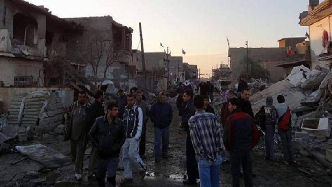 Iraqis inspect the damage following two bomb blasts in the town of Tuz Khurmatu in the Kirkuk province. (AFP)