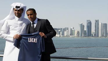 Brazilian international midfielder Lucas Moura (C) poses with Paris Saint-Germain (PSG) president and head of Qatar Sports Investments (QSI), Nasser al-Khelaifi (L) on the sidelines of a press conference held in the Museum of Islamic art in Doha on Jan. 1, 2013. (AFP)