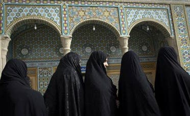 Veiled Iranian women wait in a queue to vote at a polling station in Qom during parliamentary elections on March 2, 2012. (AFP)
