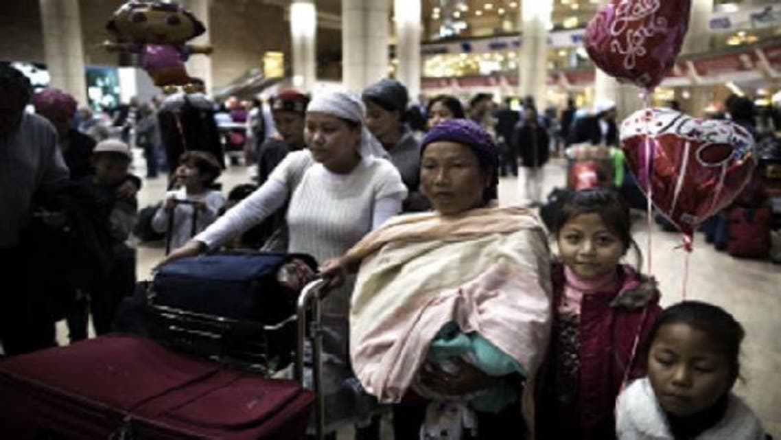 Jewish immigrants of the Bnei Menashe tribe of the Jewish community in Manipur, northeast India, wait to be reunited with family members as they arrive at Ben Gurion airport near Tel Aviv on December 24, 2012. (AFP)