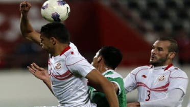 Iraq\'s Yunis Mahmud (C) vies for the ball against Tunisia\'s Walid Hichri (R) and Rami Bedoui (L) during their friendly football match in the UAE emirate of Sharjah on Dec. 30. (AFP)