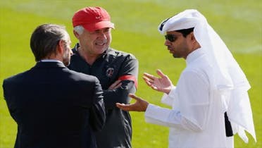Paris St Germain\'s President Nasser al-Khelaifi (R) talks with head coach Carlo Ancelotti (C) and Director General Jean-Claude Blanc before a training session at the Aspire Academy of Sports Excellence in Doha Dec. 29, 2012. (Reuters)