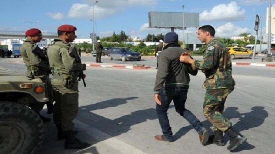 A Tunisian soldier detains a man after security forces deployed on roads leading to Douar Hicher, a Salafist hotspot near Tunis. (AFP)