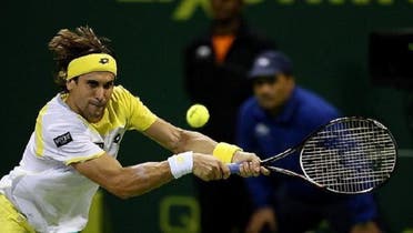 Spain\'s David Ferrer just gets the ball back to Germany\'s Dustin Brown at the ATP Qatar Open in Doha, 2013. (AFP)