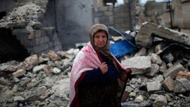 A woman walks past a house destroyed by an airstrike by Syrian government forces two days ago according to local residents in Azaz city December 18, 2012. (Reuters)