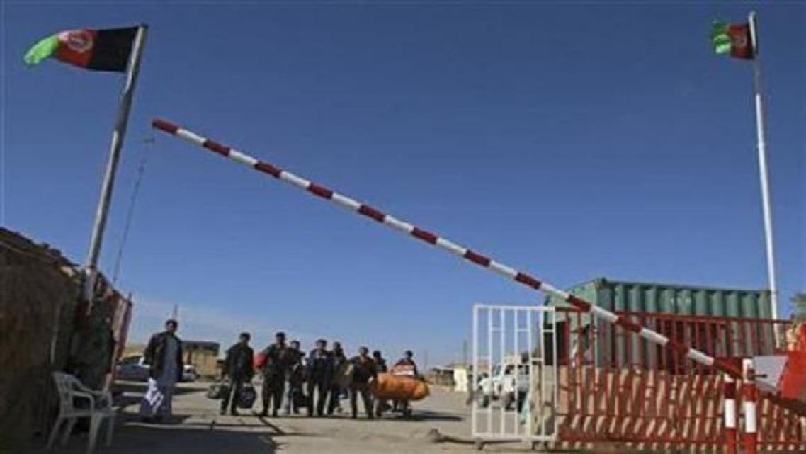 A group of Afghan migrant workers enter Afghan territory after leaving Iran at the Islam Qala border in Herat province Nov. 5, 2012. (REUTERS)