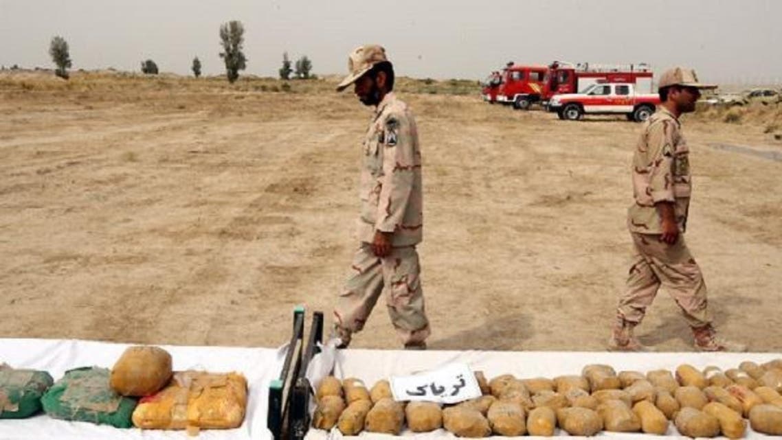 Iranian border guards display the packages of seized Afghan-made drugs at the Iran-Afghanistan border check point in Milak, south-eastern province of Sistan-Baluchestan, Iran, Oct.10, 2012. (EPA)