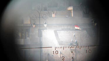 A view seen though a sniper\'s scope held for the photographer by a Free Syrian Army fighter shows a Syrian flag fluttering in an area controlled by forces loyal to Syria\'s President Bashar al-Assad. (Reuters)