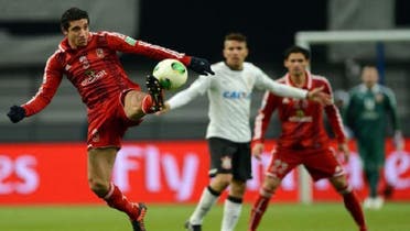 Egypt\'s Al Ahly defender Ramy Rabia (L) kicks the ball during their 2012 Club World Cup semi-final football match against Brazil\'s Corinthians in Toyota on Dec. 12, 2012. (AFP)