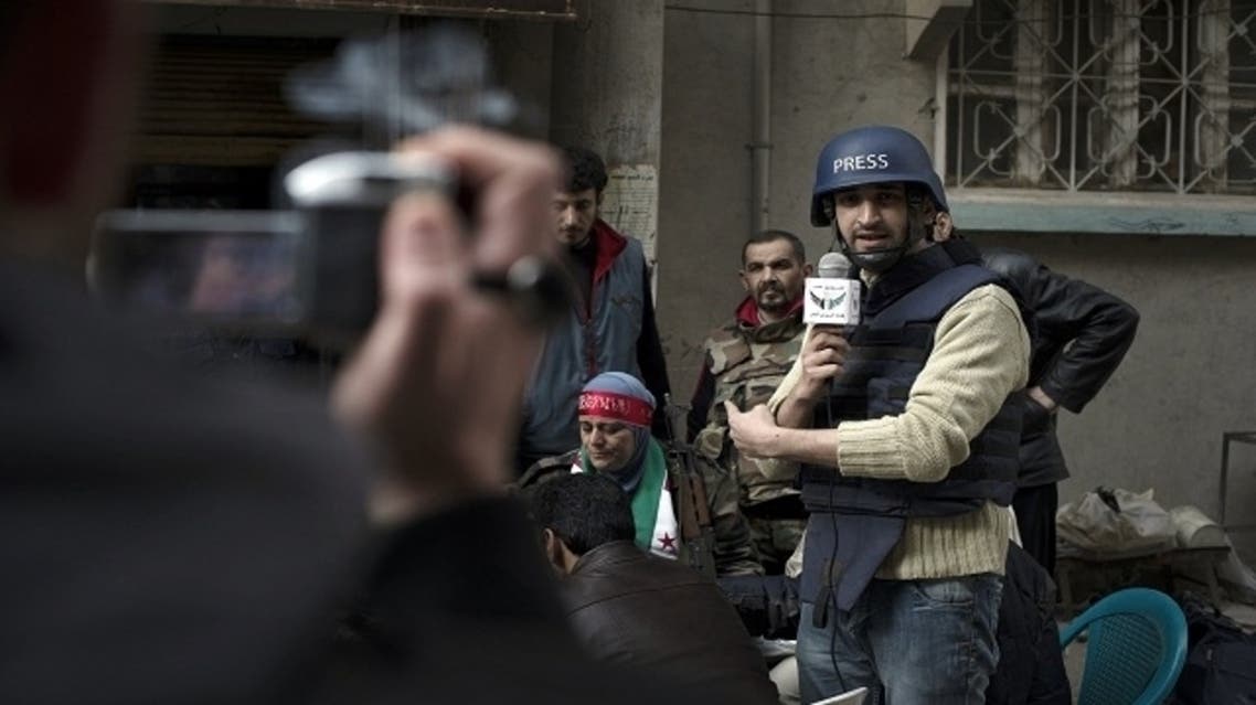 Abu Hussein (C) interviews residents and fighters in a neighborhood in the eastern Syrian town of Deir Ezzor on Feb. 19, 2013. (AFP)