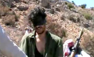 An image grab shows Austin Tice blindfolded with men believed to be his captors at an undisclosed location in Syria. (File Photo: AFP))