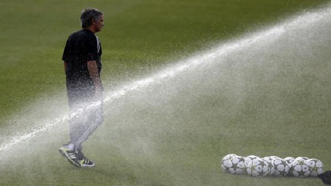 Real Madrid’s coach Jose Mourinho walks through the pitch during his team\'s training session on the eve of their Champions League soccer match against Manchester City. (Reuters)
