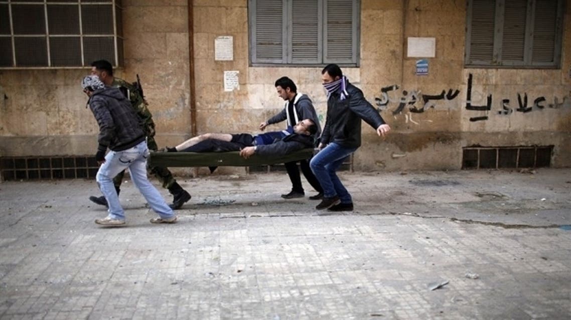 Civilians carrying out a wounded man on a stretcher after he was wounded by a sniper loyal to Syrian President Bashar el-Assad in Syria's north city of Aleppo. (Reuters)